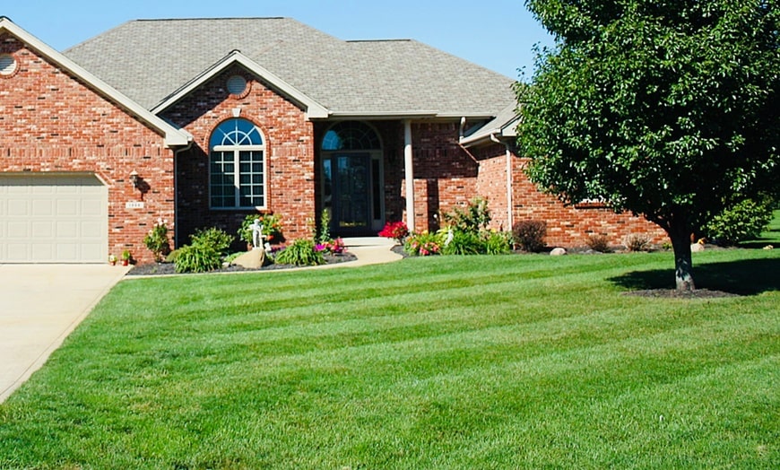 Brick house with a freshly mowed lawn